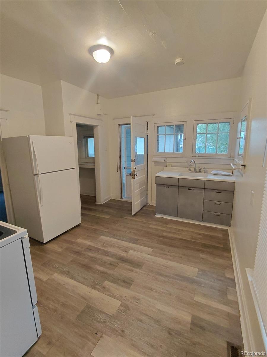 1917 South Fox Street Denver, CO 80223 - Photo 6 of 10 a view of a kitchen with refrigerator and cabinets