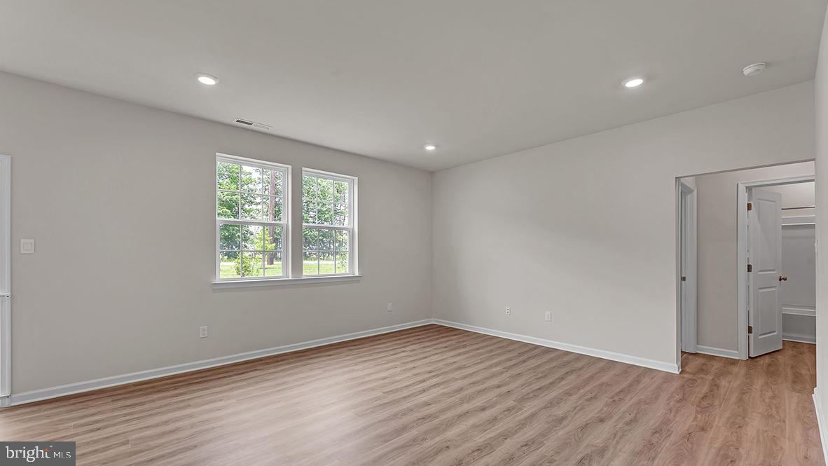 155 Littleworth Road Manahawkin, NJ 08050 - Photo 13 of 32 a view of an empty room with wooden floor and a window