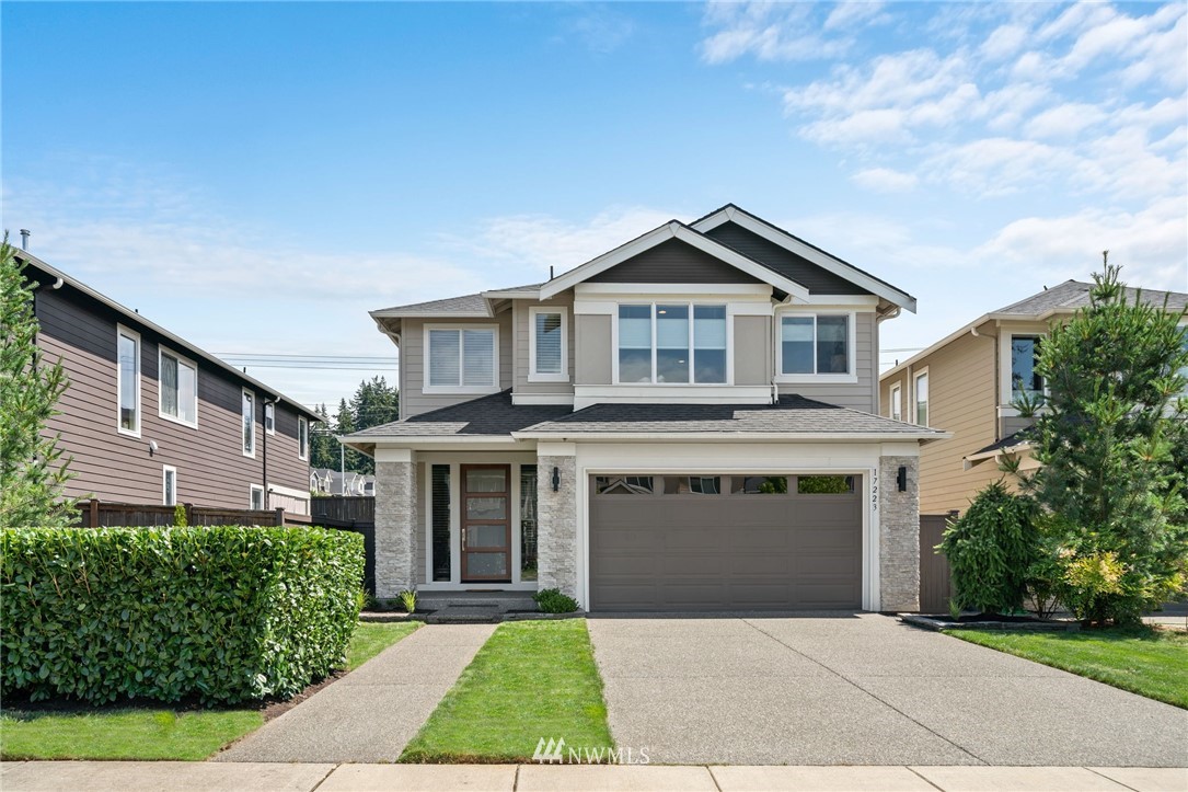 a front view of a house with a garden