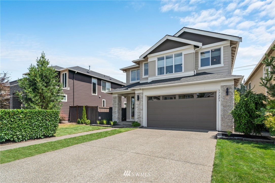 17223 40th Avenue Southeast Bothell, WA 98012 - Photo 2 of 37 a front view of a house with a yard and garage