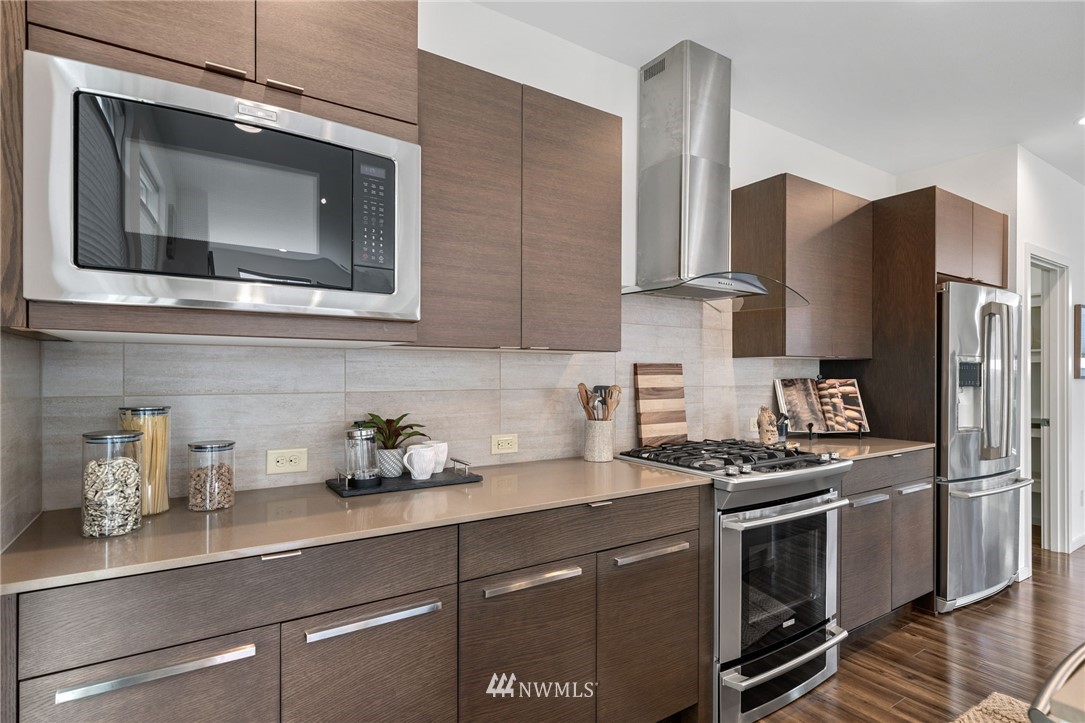 17223 40th Avenue Southeast Bothell, WA 98012 - Photo 14 of 37 a kitchen with stainless steel appliances a stove a microwave and refrigerator