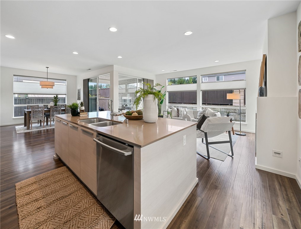 17223 40th Avenue Southeast Bothell, WA 98012 - Photo 15 of 37 a kitchen with stainless steel appliances granite countertop a lot of counter space and wooden floors