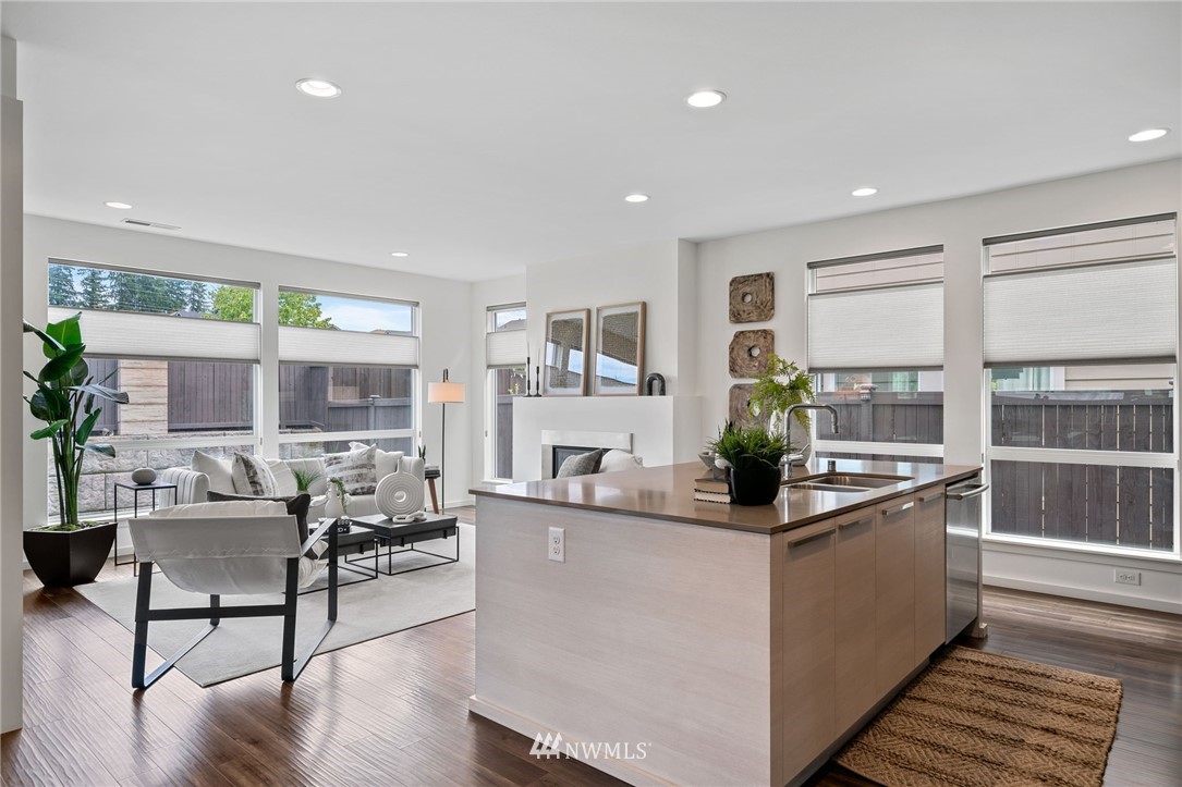 17223 40th Avenue Southeast Bothell, WA 98012 - Photo 17 of 37 a kitchen with stainless steel appliances granite countertop sink stove and wooden floor