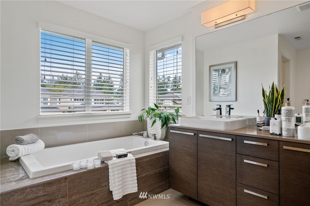 17223 40th Avenue Southeast Bothell, WA 98012 - Photo 29 of 37 a bathroom with a granite countertop sink and a bathtub