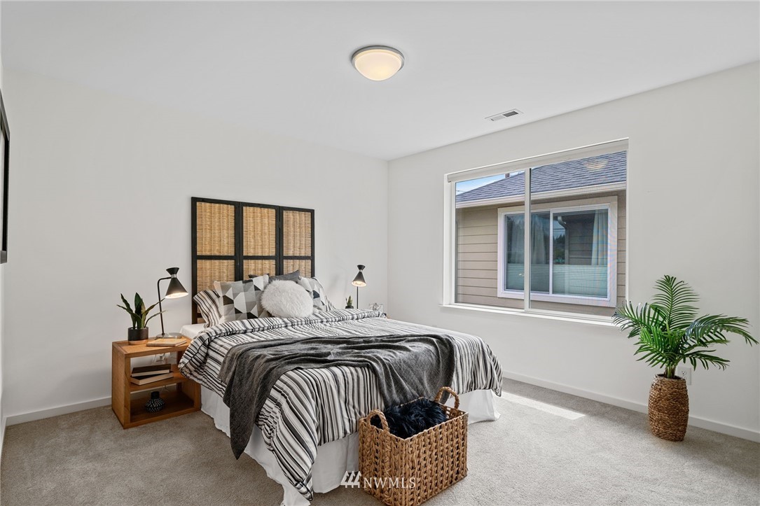 17223 40th Avenue Southeast Bothell, WA 98012 - Photo 34 of 37 a bedroom with a bed and a potted plant