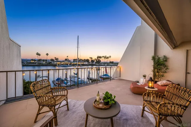 a view of a chair and tables in the balcony