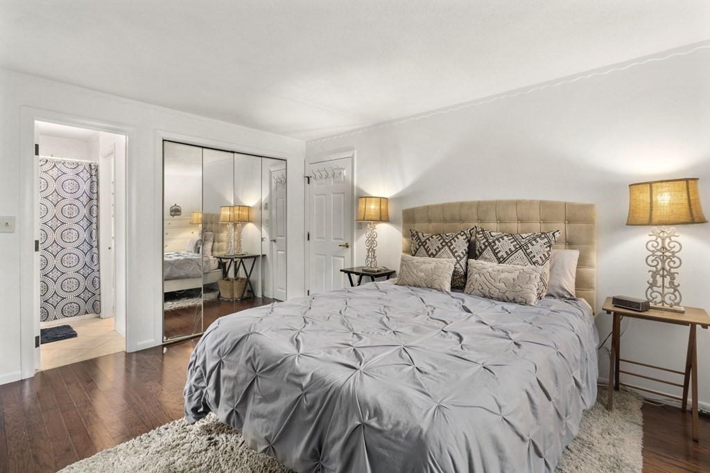 99 Graymore Road Waltham, MA 02451 - Photo 12 of 38 a bedroom with a large bed and a wooden floor