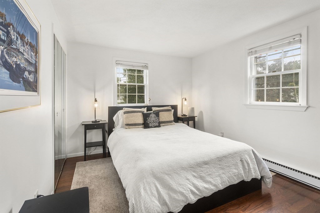 99 Graymore Road Waltham, MA 02451 - Photo 13 of 38 a large bed sitting in a bedroom next to a window and a chair