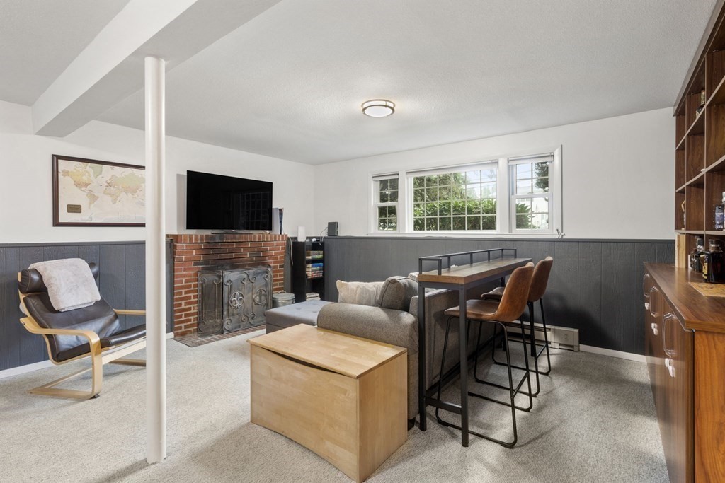 99 Graymore Road Waltham, MA 02451 - Photo 17 of 38 a living room with furniture a flat screen tv and a fireplace