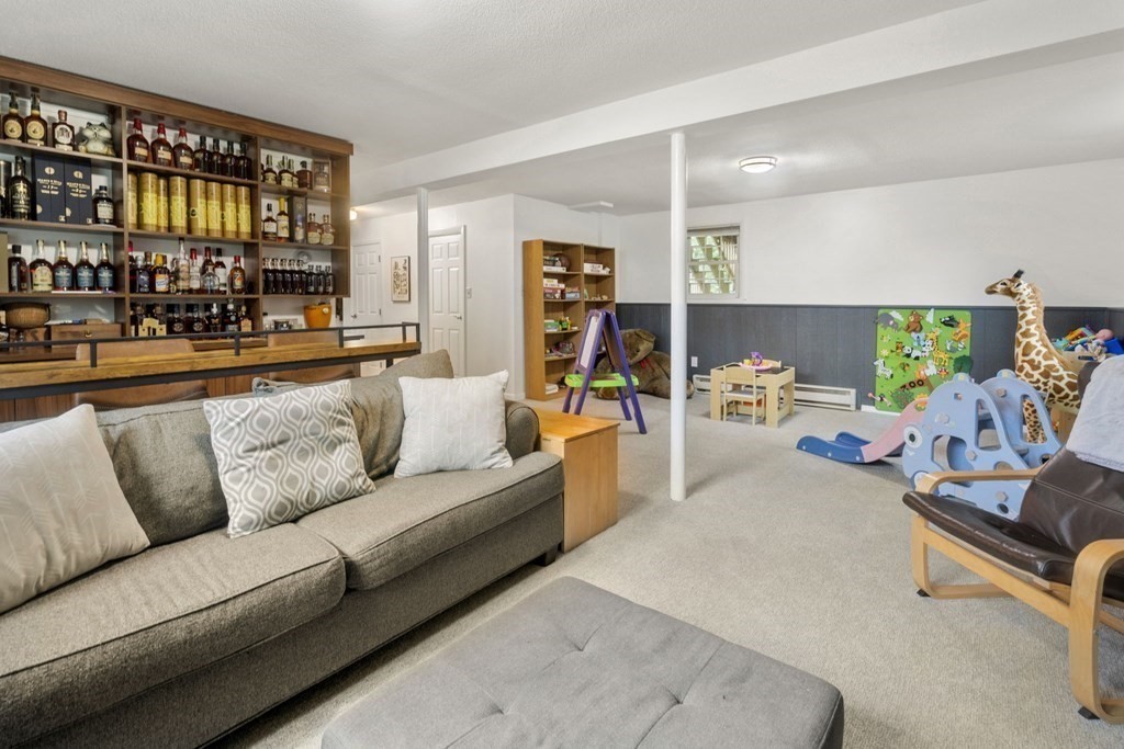 99 Graymore Road Waltham, MA 02451 - Photo 19 of 38 a living room with furniture and a book shelf