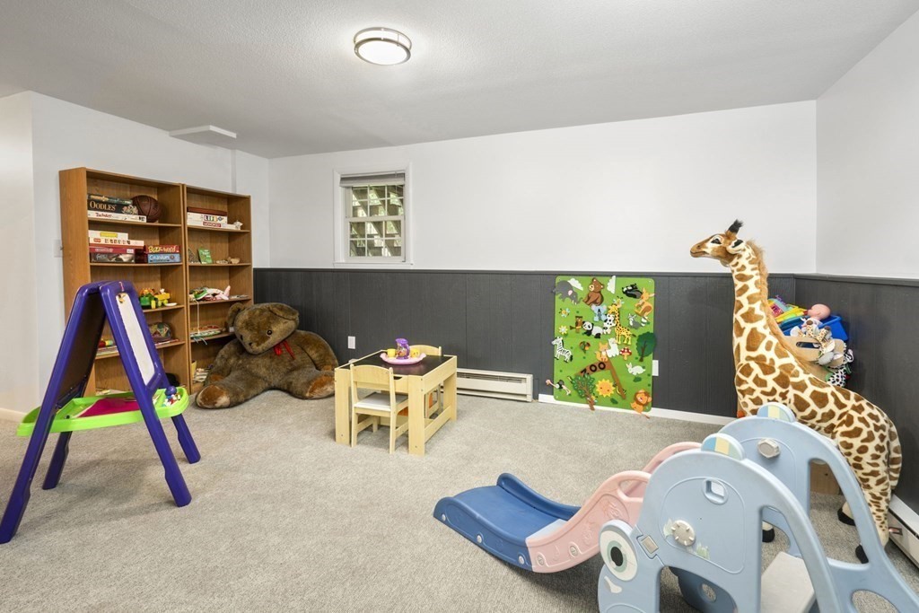 99 Graymore Road Waltham, MA 02451 - Photo 20 of 38 a bedroom with furniture and a wooden floor
