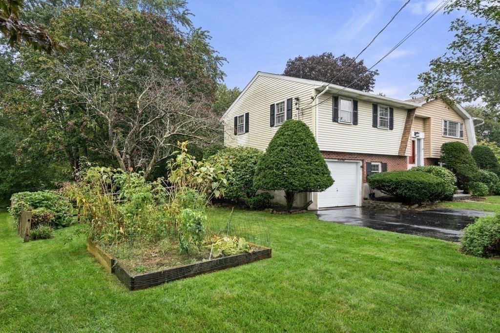 99 Graymore Road Waltham, MA 02451 - Photo 27 of 38 a front view of a house with a garden