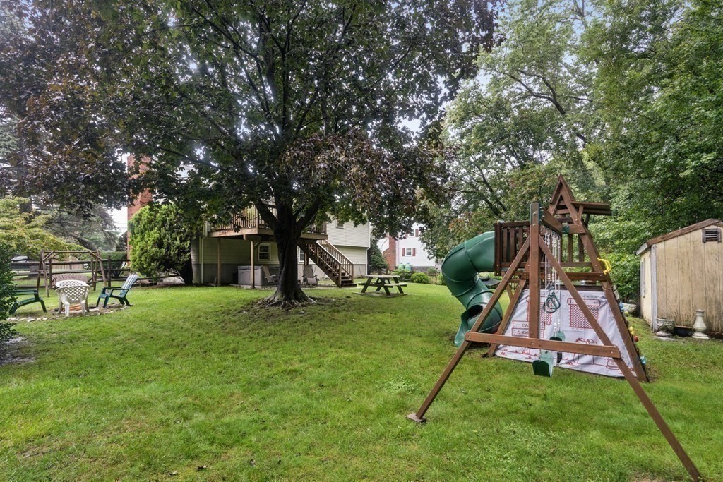 99 Graymore Road Waltham, MA 02451 - Photo 34 of 38 a view of an house with a backyard and a tree