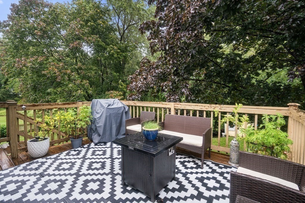 99 Graymore Road Waltham, MA 02451 - Photo 37 of 38 a view of a chairs and table on the wooden roof