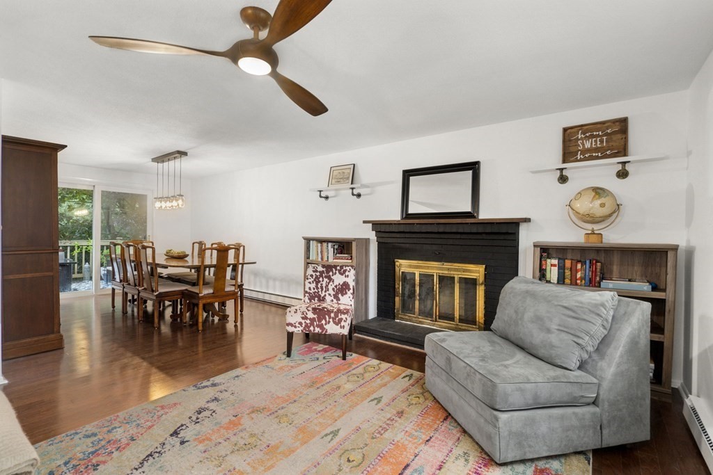 99 Graymore Road Waltham, MA 02451 - Photo 5 of 38 a living room with furniture a fireplace and a table