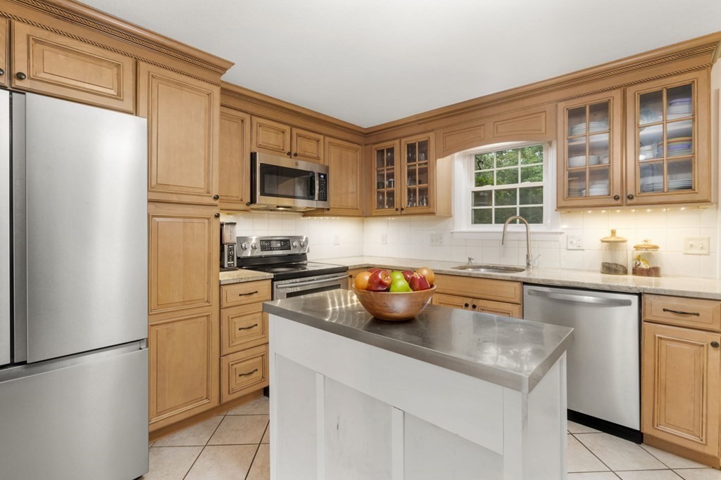 99 Graymore Road Waltham, MA 02451 - Photo 8 of 38 a kitchen with stainless steel appliances a refrigerator sink and microwave