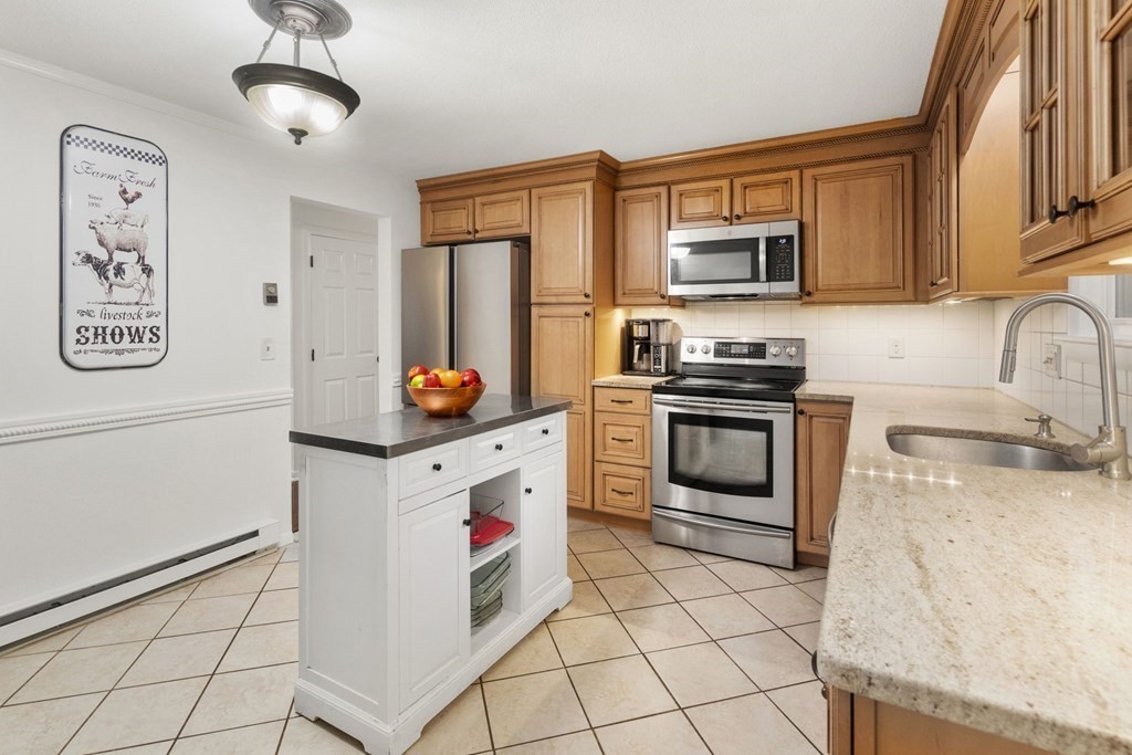 99 Graymore Road Waltham, MA 02451 - Photo 9 of 38 a kitchen with stainless steel appliances granite countertop a stove and a sink