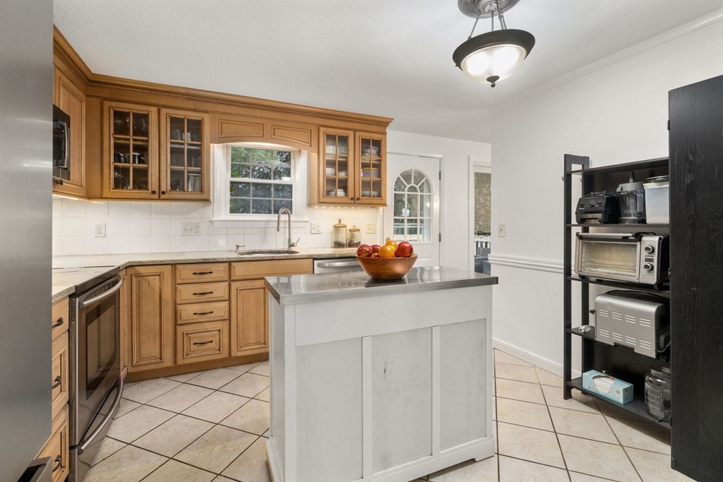 99 Graymore Road Waltham, MA 02451 - Photo 10 of 38 a kitchen with stainless steel appliances a stove microwave and refrigerator