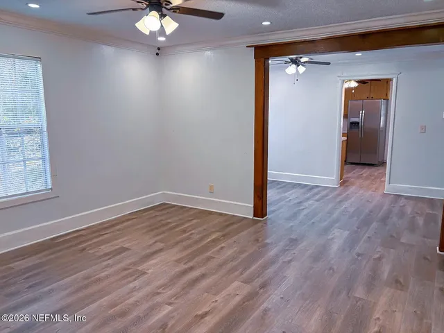 wooden floor in an empty room with a window