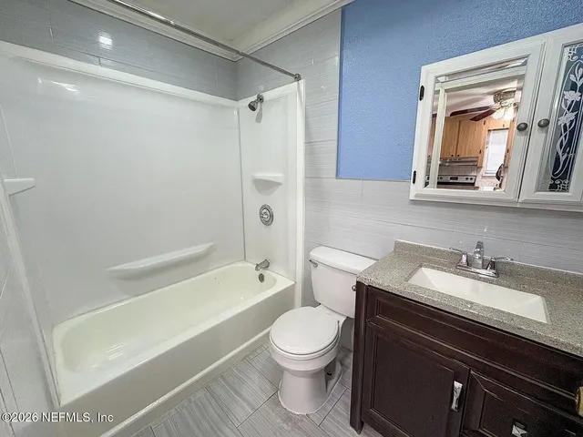 a bathroom with a sink a toilet and a bathtub