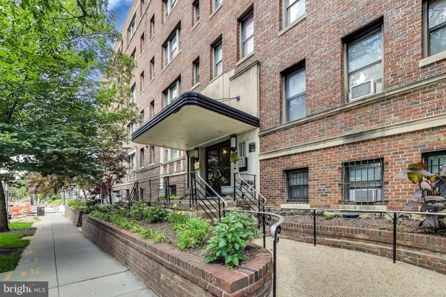 a front view of a building with garden