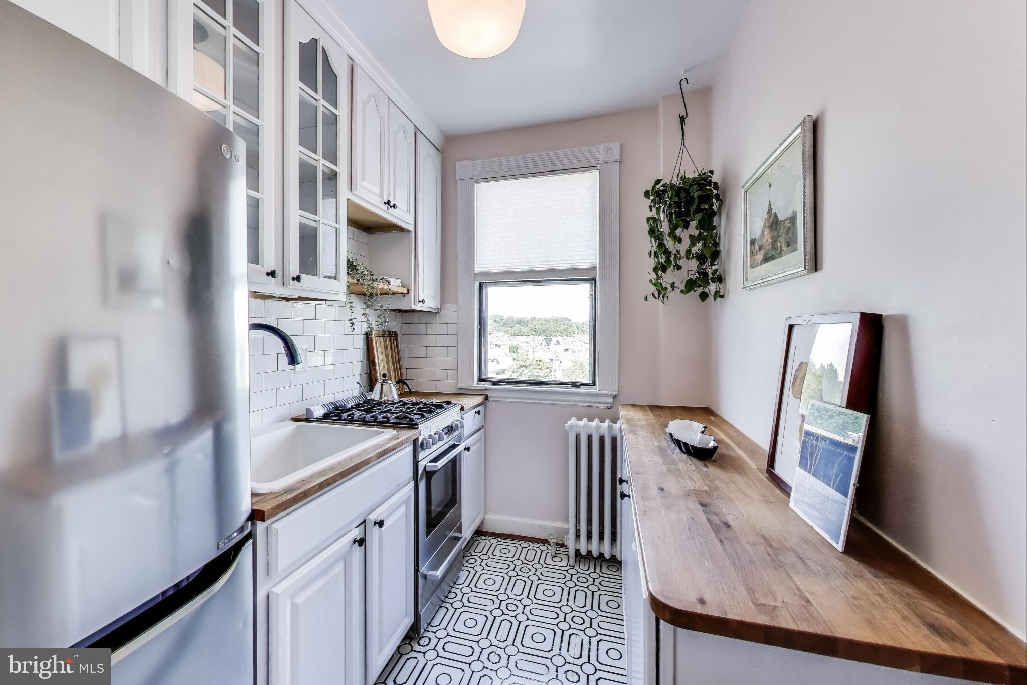 1365 Kennedy Street Northwest, Unit 506 Washington, DC 20011 - Photo 6 of 24 a kitchen with stainless steel appliances granite countertop a stove a sink dishwasher and a refrigerator