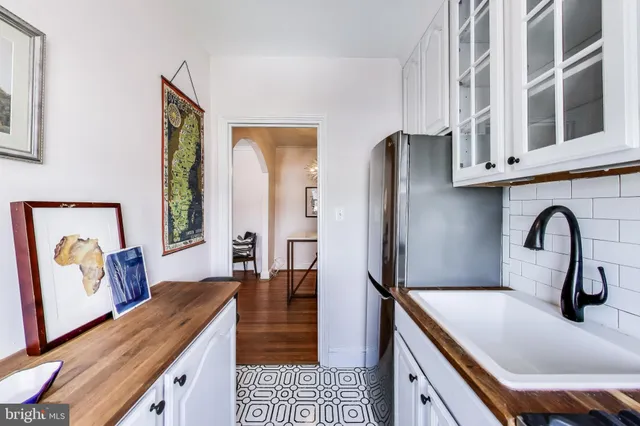 a kitchen with stainless steel appliances granite countertop a sink and a refrigerator