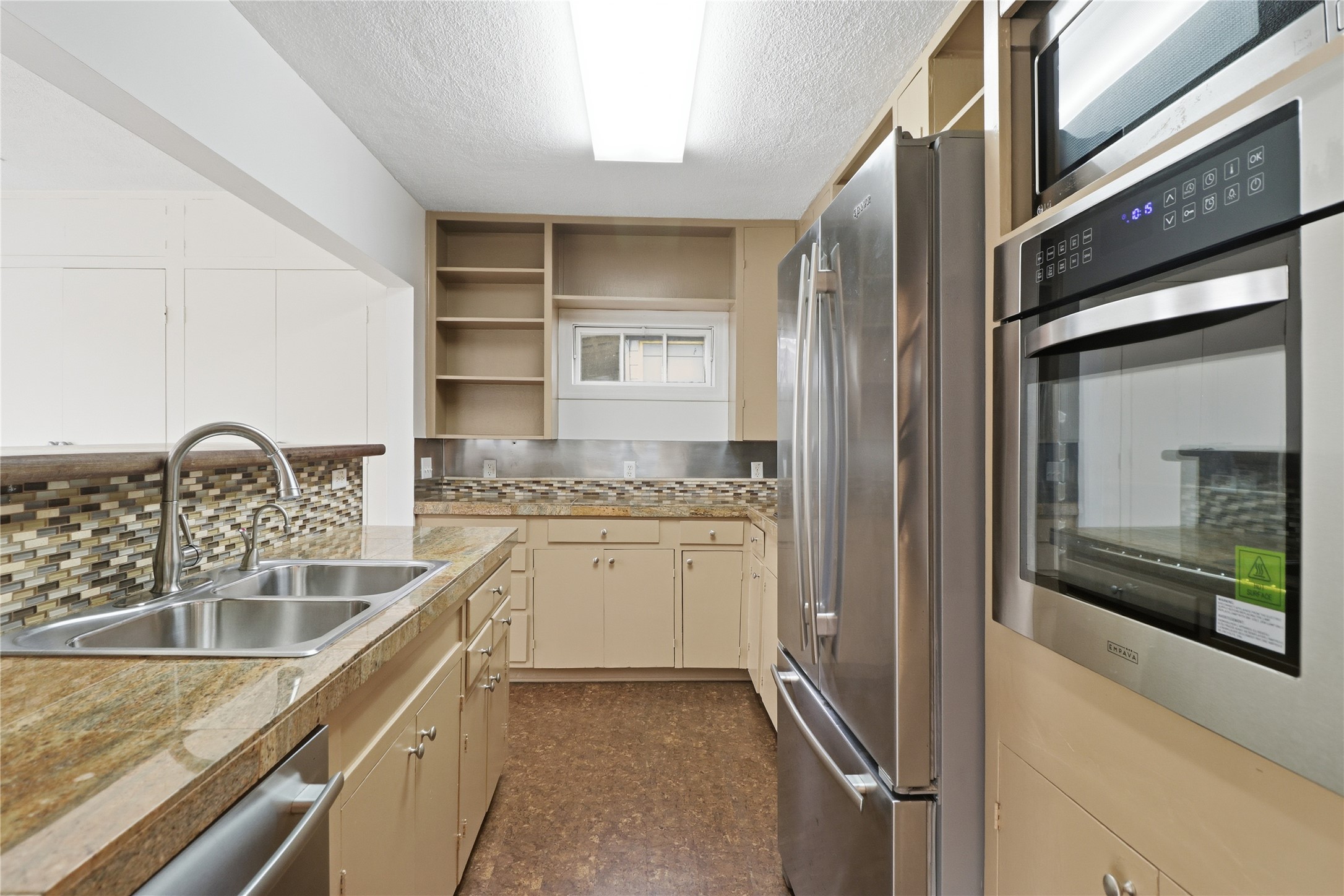 2007 Montclaire Street Austin, TX 78704 - Photo 6 of 27 a kitchen with a granite countertop sink and refrigerator