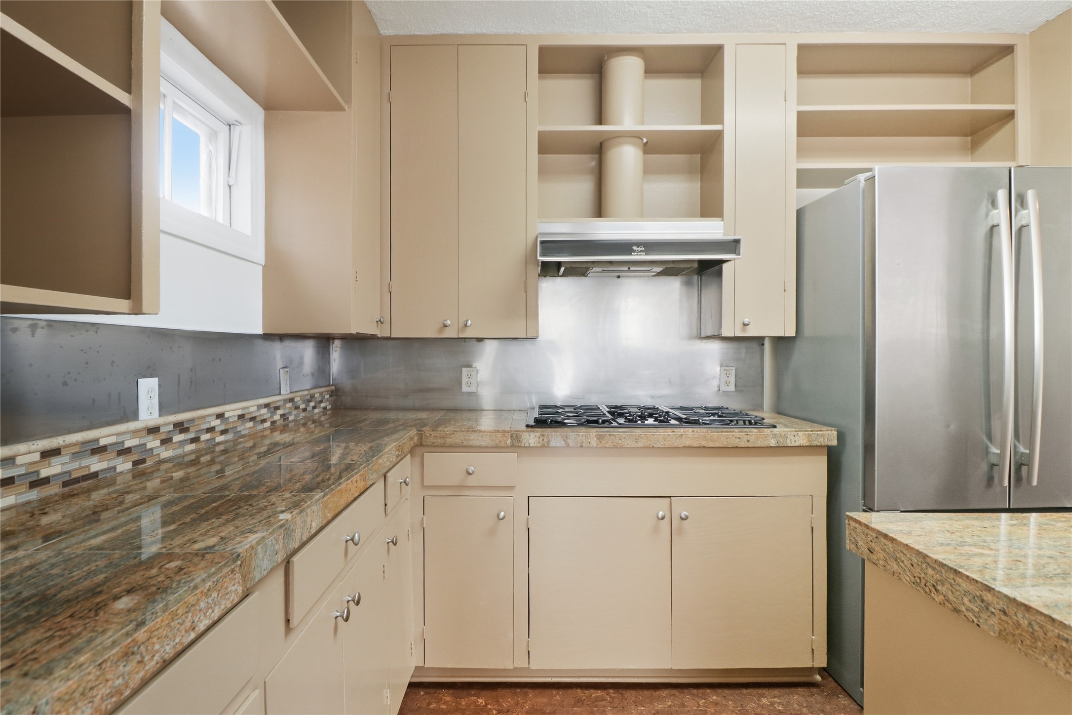 2007 Montclaire Street Austin, TX 78704 - Photo 7 of 27 a kitchen with stainless steel appliances granite countertop a sink stove and refrigerator