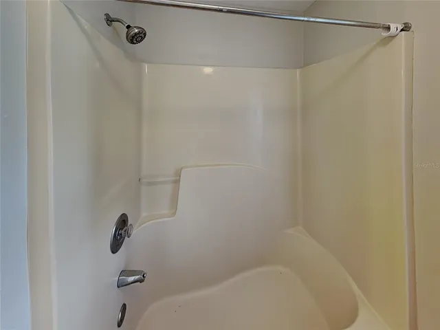 a bathroom with a shower and a bath tub