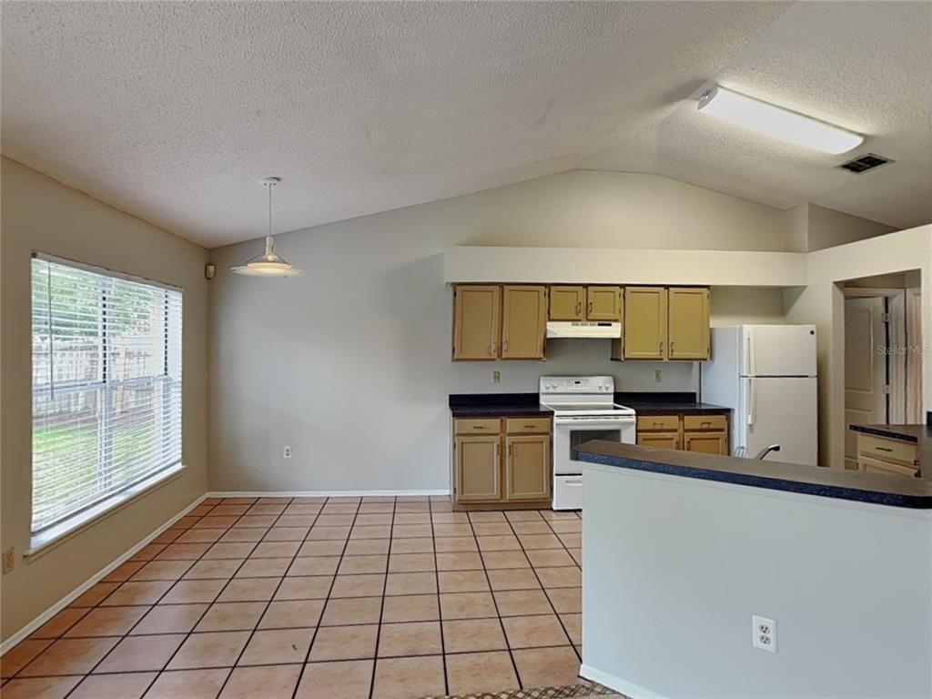 1618 Cassingham Circle Ocoee, FL 34761 - Photo 5 of 15 a kitchen with a refrigerator and a stove