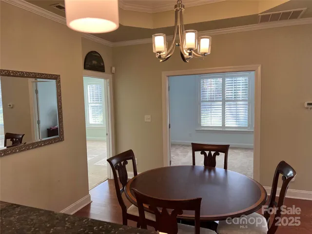 a view of a dining room with furniture and chandelier