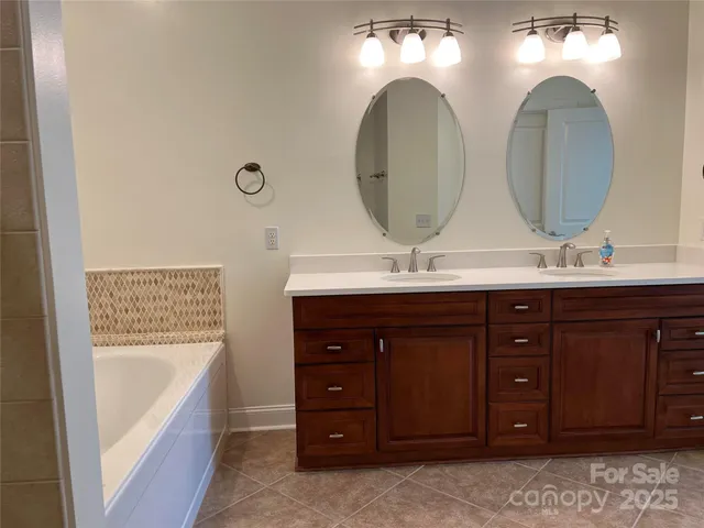 a bathroom with a double vanity sink and a mirror