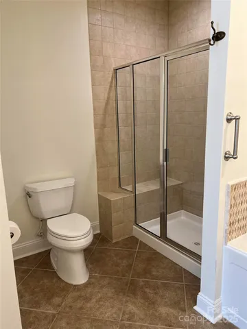 a bathroom with a toilet and a shower