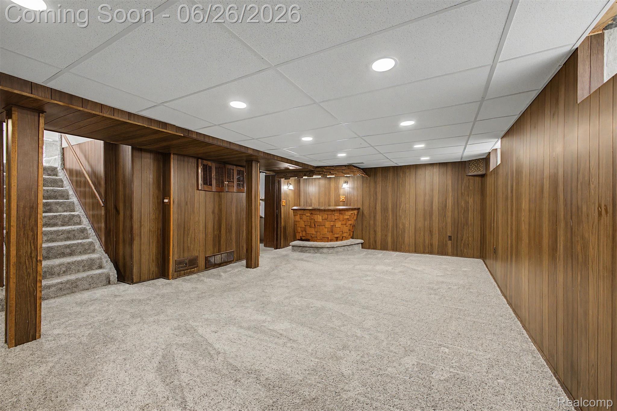 2216 Banner Street Dearborn, MI 48124 - Photo 25 of 34 Finished lower level featuring recessed lighting, a drop ceiling, wood-paneled walls, and a built-in bar with stone accents