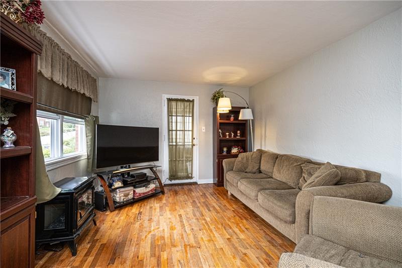 1721 Elderslee Road Pittsburgh, PA 15227 - Photo 5 of 16 Living room with door to 3 seasons room.