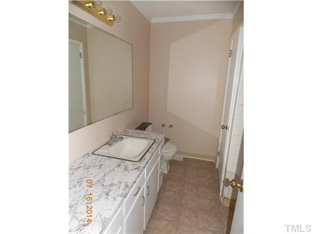 5657 Benson Hardee Road Benson, NC 27504 - Photo 8 of 16 a bathroom with a sink and a mirror