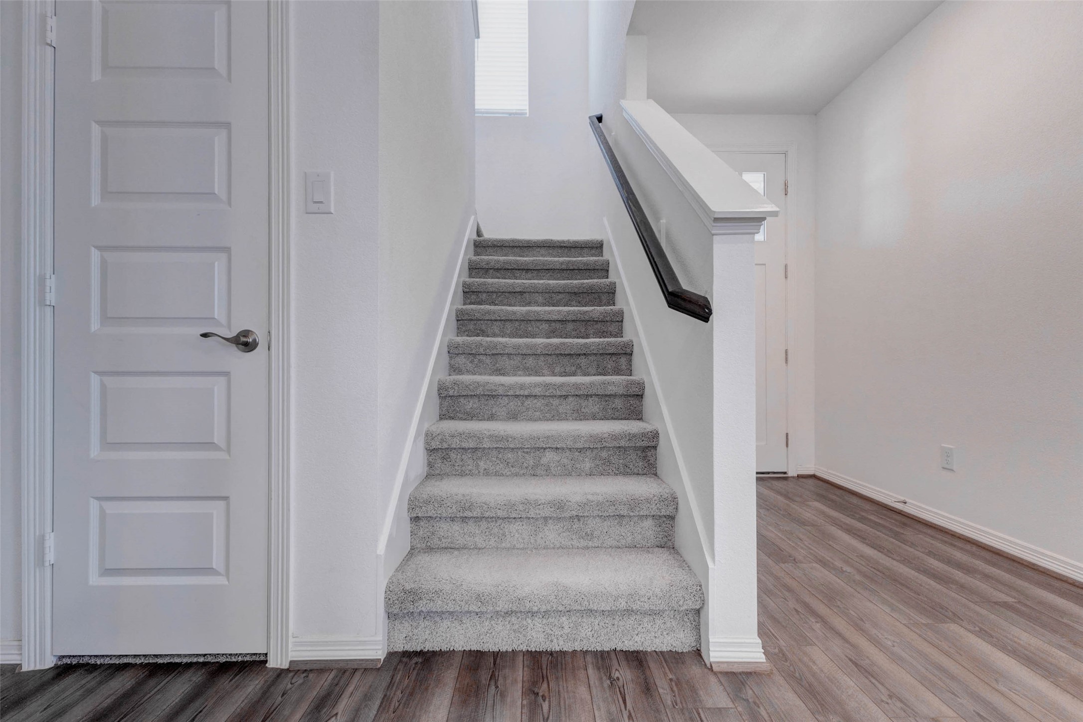 32418 Fly Fish Way Fulshear, TX 77441 - Photo 23 of 40 The carpeted staircase with its sleek dark handrail leads you to the second level of the home, where a game room and additional guest bedrooms await.