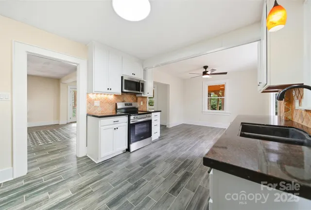 a kitchen with a sink appliances and cabinets
