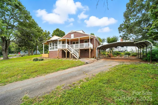 a view of a house with a yard and sitting area