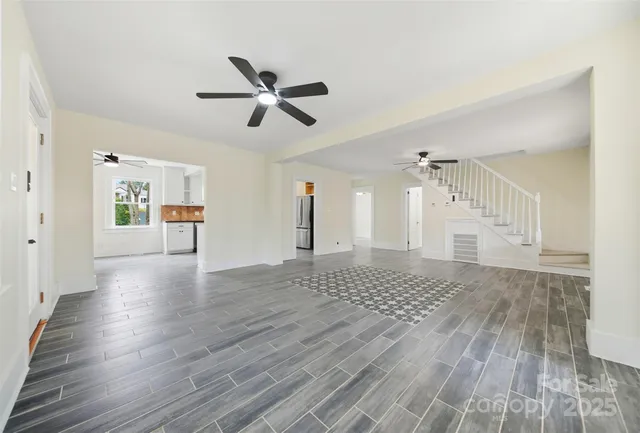 a view of a livingroom with wooden floor and white walls