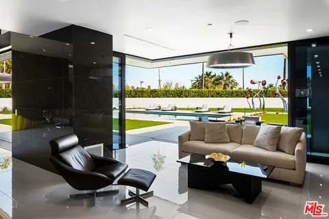 a living room with chair and wooden floor