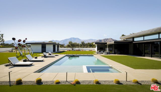 a view of a swimming pool with chairs