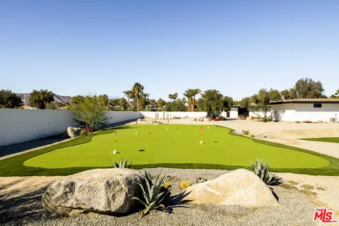 a view of a swimming pool with a table and chairs