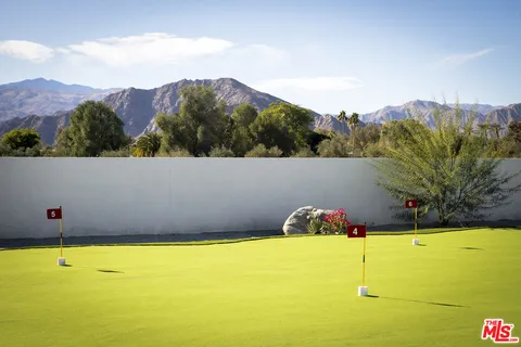 a view of a house with swimming pool and a yard