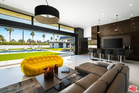 a view of living room with furniture and floor to ceiling window