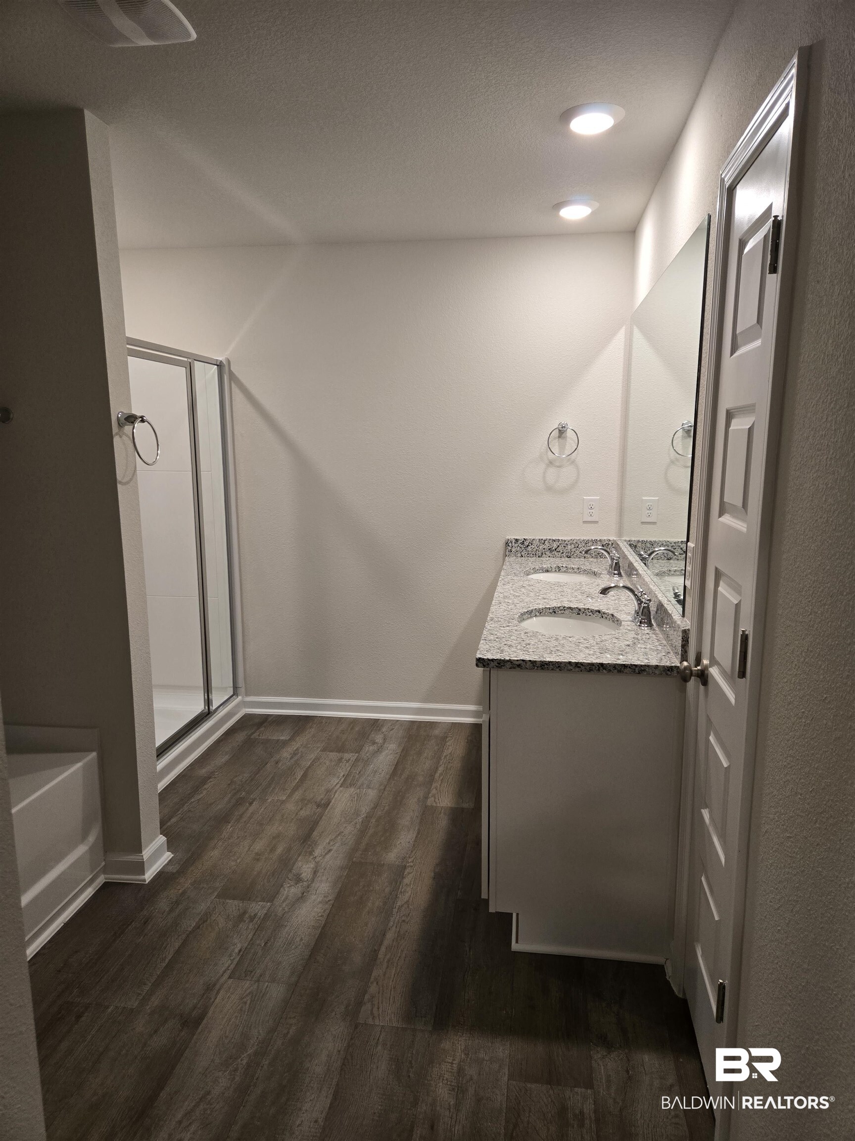24194 Veranda Circle Elberta, AL 36530 - Photo 25 of 31 Bathroom featuring plus walk in shower, wood-type flooring, vanity, and a textured ceiling