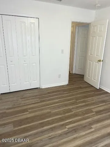 a view of a room with wooden floor