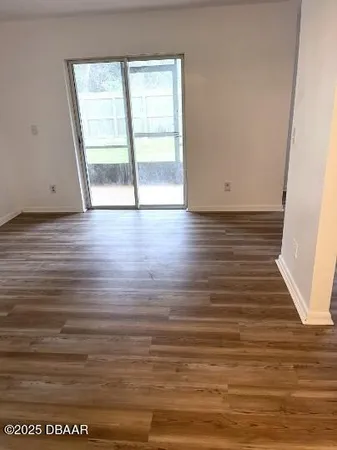 a view of wooden floor and windows in a room