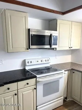 a kitchen with a stove and a microwave